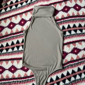Sleeveless Tan turtleneck bodysuit